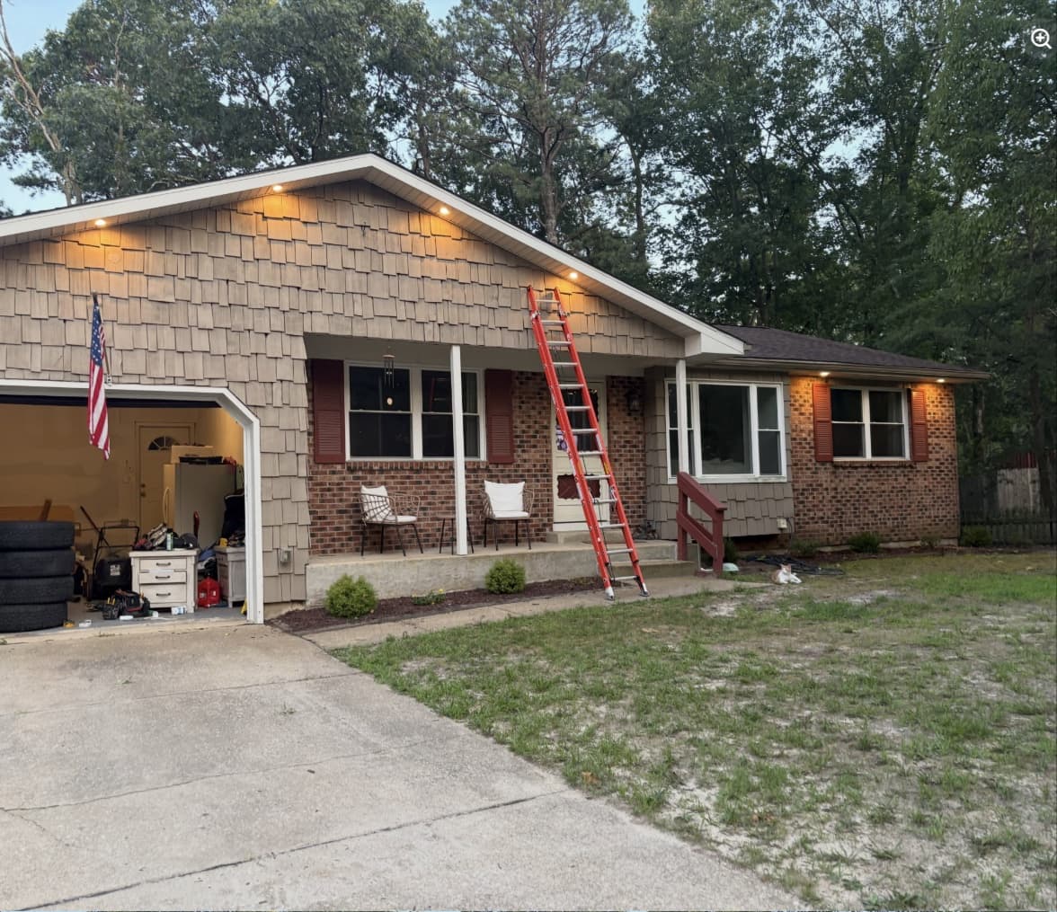 The same South Jersey ranch in daylight with a ladder up during the recessed lighting install